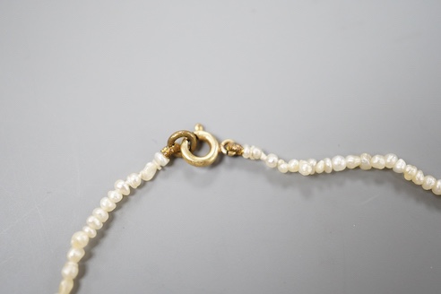 A multi coloured paste and opal doublet set baroque seed pearl necklace, 42cm.